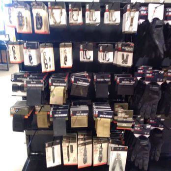 5.11 Tactical - Good sale right here. - A retail display at 5.11 Tactical features various tactical accessories such as knives, sheaths, and gloves, arranged on a black stand. - Outdoor Gear Near Me - Albuquerque, New Mexico