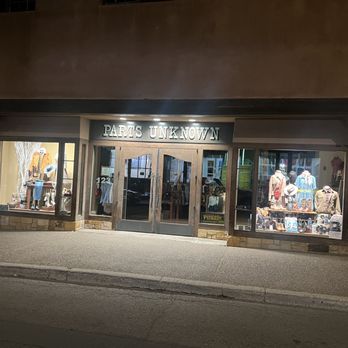 Parts Unknown - Stealthily Disguised - Parts Unknown is a retail store selling clothing and accessories, with large display windows and illuminated signage. - Shoe Stores Near Me - Santa Fe, New Mexico