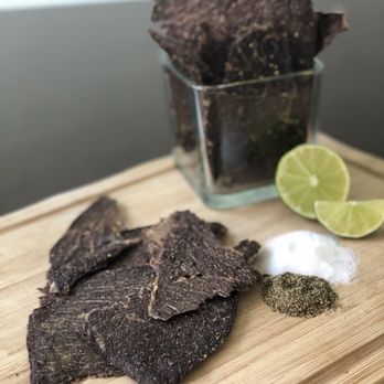 Villalobos Beef Jerky - a cutting board with chips and lime - Specialty Food Near Me - Albuquerque, New Mexico