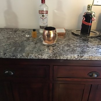 Keystone Granite - a granite counter top with a bottle of liquor on it - Countertop Installation Near Me - Fletcher, North Carolina