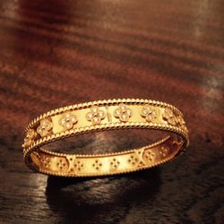 Andrew Fabrikant & Sons - Van Cleef & Arpels Yellow Gold and Diamond Bangle.