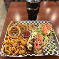 Phillies Cheesesteaks - Philly Cheesesteak with mushrooms, onions, American Cheese, lettuce, and mayo with onion rings and curly fries