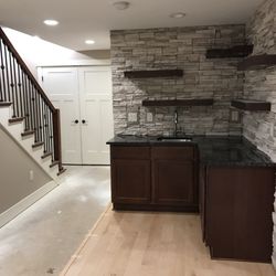 Midwest Remodel and Repair - basement remodel - buildout: floating shelves on stone wall in kitchenette