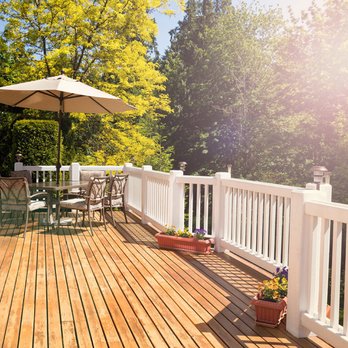 Fixit Home Remodeling - a deck with chairs and an umbrella - General Contractors Near Me