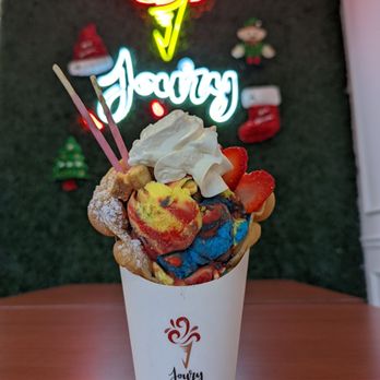 Joury Ice-Cream & Cafe - Bubble waffle with Superman ice cream, Pocky, cheesecake bites, strawberries, and whipped cream - Creperies Near Me - Orlando, Florida Joury Ice-Cream & Cafe - Bubble waffle with Superman ice cream, Pocky, cheesecake bites, strawberries, and whipped cream - Creperies Near Me - Orlando, Florida