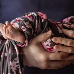 Parenthood in Bloom - A father holding his new baby.