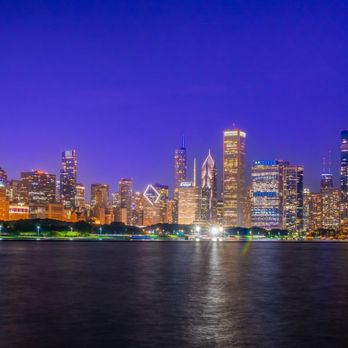 Chicago Skyline - Beautiful Chicago Skyline - A nighttime cityscape of Chicago with illuminated skyscrapers along Lake Michigan, featuring the Willis Tower and other tall buildings. - Local Flavor Near Me - Chicago, Illinois