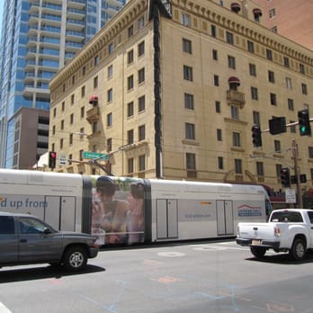 METRO light rail - METRO light rail rolls past the Hotel San Carlos in downtown Phoenix. - Public Transportation Near Me - Phoenix, Arizona METRO light rail - METRO light rail rolls past the Hotel San Carlos in downtown Phoenix. - Public Transportation Near Me - Phoenix, Arizona