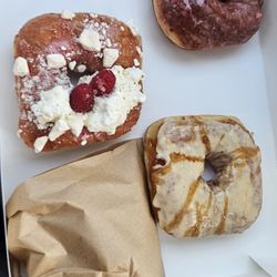 Zi, Pavlova, and Berry donuts and bag of sugar & spice donut holes