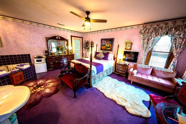 Colette Suite | Queen - Romantic Victorian Parisian Queen Jacuzzi Suite with seating space, private balcony for 2, and a shared front porch. Overlooks downtown from your 2nd floor window.

Romantic Victorian purple room
2nd Floor balcony for two next to private mountain cliff
Window view overlooking downtown from your Victorian seating area
Two-person Jacuzzi
Separate private bathroom with walk-in shower
Easy access to shared front porch overlooking downtown