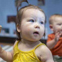 Babies playing with music makers.