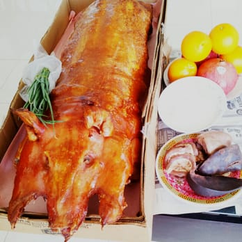 Chun's Meat Market - Whole Roast Pig needs to be ordered 1 week in advance. This 35 pound beast costs $225. Entrails (lower right) included. - Barbeque Near Me - Honolulu, Hawaii