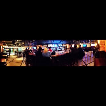 M Bar - a group of people sitting at a bar - Sports Bars Near Me - Chicago, Illinois