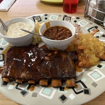 Mr D'z Route 66 Diner - Half rack of ribs with coconut shrimp. Mashed potatoes and cole slaw are hiding behind the gravy and baked beans. - Diners Near Me - Kingman, Arizona