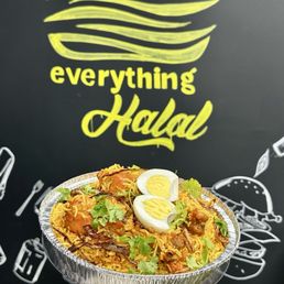 Biryanis - A foil container of chicken biryani is held by a person wearing a white sleeve, with a black wall featuring a yellow logo and illustrations in the background.