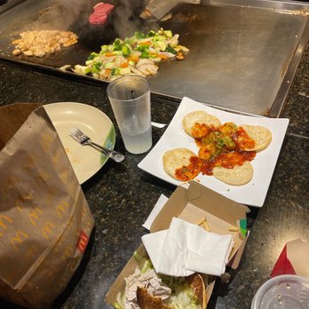 Kampai - a person preparing food in a kitchen - Japanese Near Me - Lawrenceville, Georgia Kampai - a person preparing food in a kitchen - Japanese Near Me - Lawrenceville, Georgia