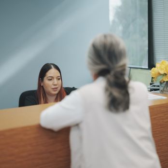 K Wellness Center - Staff helping customer at front desk of K Wellness Holistic Health Spa in Long Beach, CA. - IV Hydration Near Me - Long Beach, California