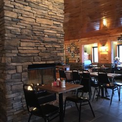Greentown Grille - Chalet-style dining room punctuated by an three sided fireplace!