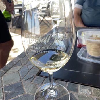 Mitchell Katz Winery - a glass of wine on a table - Wineries Near Me - Livermore, California Mitchell Katz Winery - a glass of wine on a table - Wineries Near Me - Livermore, California