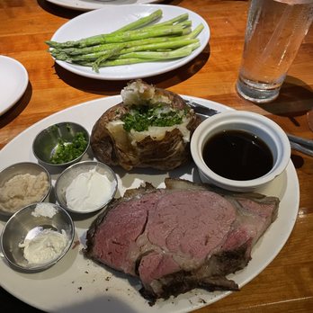 Stoney River - Prime Rib with Au Jus and Horseradish, Baked Potato with sour cream, butter, and chives. - Steakhouses Near Me - Chapel Hill, North Carolina Stoney River - Prime Rib with Au Jus and Horseradish, Baked Potato with sour cream, butter, and chives. - Steakhouses Near Me - Chapel Hill, North Carolina