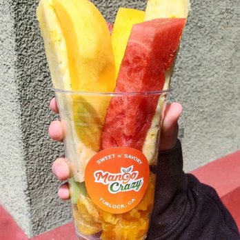 Mango Crazy - Fruit Cup (16 or 24oz available). Includes Oranges, Pineapple, Watermelon, Jicama, Mango, Cucumber with hot sauce, tajin and lime! - Desserts Near Me - Turlock, California Mango Crazy - Fruit Cup (16 or 24oz available). Includes Oranges, Pineapple, Watermelon, Jicama, Mango, Cucumber with hot sauce, tajin and lime! - Desserts Near Me - Turlock, California
