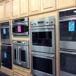 Bray & Scarff - Multiple built in wall ovens on display with wooden cabinetry