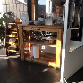 Sol Grill - Water table with the pandemic hands sanitizer. - New American Near Me - Newport Beach, California