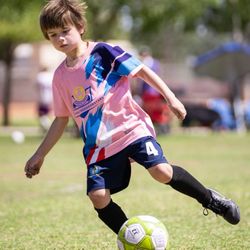 United Youth Soccer Stars - U9 player from the pink lightning putting on a show on the pitch.