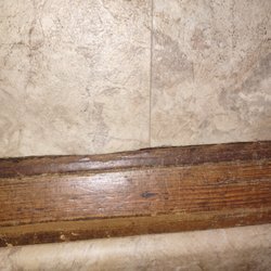 Didn't install trim or put under existing trim. Bottom of picture is floor installed by different company with very nice trim