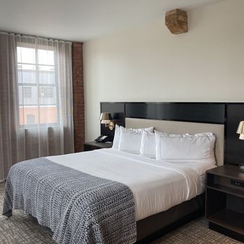 The Wilbur Lititz, Tapestry Collection by Hilton - Comfy king bed flanked by dimmable lights and end tables with USB ports. - Hotels Near Me - Lititz, Pennsylvania The Wilbur Lititz, Tapestry Collection by Hilton - Comfy king bed flanked by dimmable lights and end tables with USB ports. - Hotels Near Me - Lititz, Pennsylvania