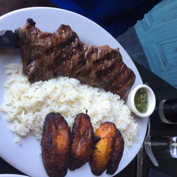Mambo Grill & Tapas - Churrasco, with perfectly cooked Plantains, and well seasoned White Rice, and the Chimichurri Sauce. - Tapas/Small Plates Near Me - Salisbury, North Carolina Mambo Grill & Tapas - Churrasco, with perfectly cooked Plantains, and well seasoned White Rice, and the Chimichurri Sauce. - Tapas/Small Plates Near Me - Salisbury, North Carolina