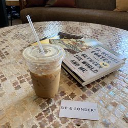 Sip & Sonder - Iced latte with macadamia nut milk They also have cultural books out for leisure reading