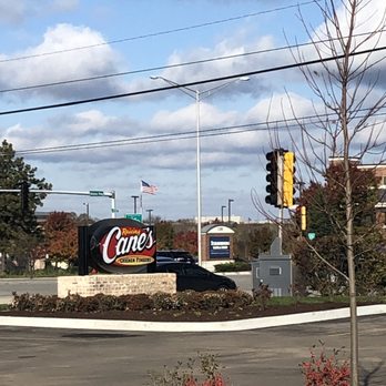 Raising Cane's Chicken Fingers - Sign at Higgins Rd light. - Fast Food Near Me - Schaumburg, Illinois Raising Cane's Chicken Fingers - Sign at Higgins Rd light. - Fast Food Near Me - Schaumburg, Illinois