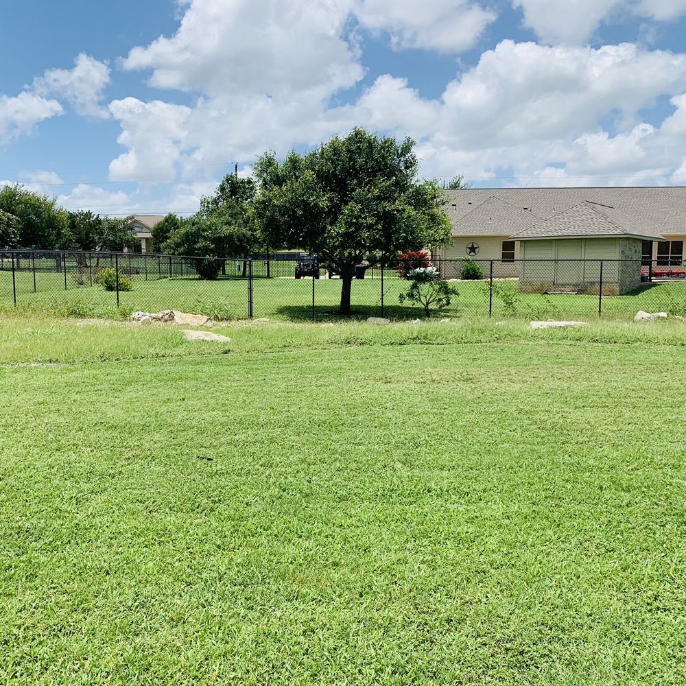 Liberty Lawn Care - a fenced in yard - Landscaping Near Me