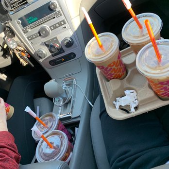 Dunkin' -  a person holding a tray of drinks in a car - Donuts Near Me - Fishers, Indiana