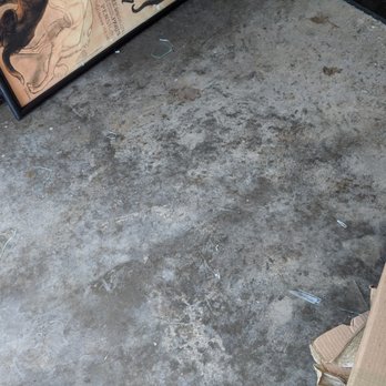 American Van Lines - Broken glass (from the broken frame) on the floor of our garage. - Movers Near Me - Pompano Beach, Florida