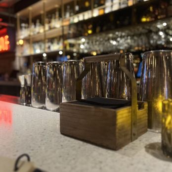 The Ventura Room - a row of wine glasses on a bar counter - Cocktail Bars Near Me - Vancouver, British Columbia The Ventura Room - a row of wine glasses on a bar counter - Cocktail Bars Near Me - Vancouver, British Columbia
