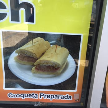 Sandwich King - a sandwich on a plate in front of a sign - Sandwiches Near Me - Miami, Florida