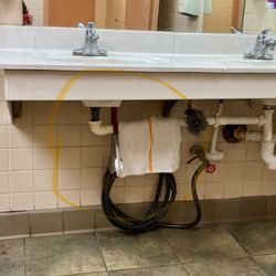 China Buffet - Women's bathroom, food serving tongs under the bathroom sink