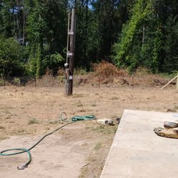 J & A fencing - 4' red brand field fence with round wood posts, round wood kickers & multiple farm gates.