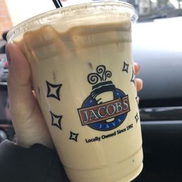 a hand holding a cup of iced coffee a hand holding a cup of iced coffee