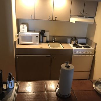 Bahia Resort Hotel - Electric stove w/oven, awkwardly-shaped sink, microwave, fridge in lower left cabinet, dishes and cookware in top cabinets - San Diego, CA