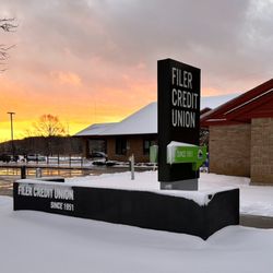 Filer Credit Union - Filer Credit Union sign covered in snow at sunset.