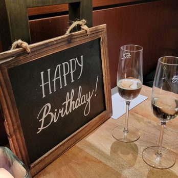 Seasons 52 - Happy birthday sign and complimentary flutes of champagne - New American Near Me - Jacksonville, Florida Seasons 52 - Happy birthday sign and complimentary flutes of champagne - New American Near Me - Jacksonville, Florida