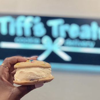 Tiff's Treats - a person holding a sandwich - Bakeries Near Me - Nashville, Tennessee