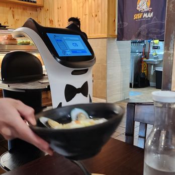 Sushi Man - The waiter helps the little robot - Sushi Bars Near Me - Champaign, Illinois