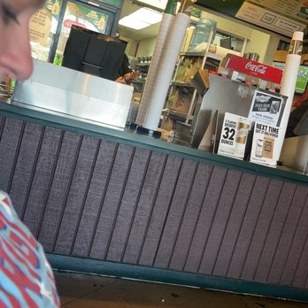Wingstop - a girl looking at her cell phone - Chicken Wings Near Me - Phoenix, Arizona