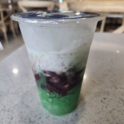 Street Pho - Chè Ba Màu, is red beans, mung beans, and pandan-flavored jelly layered in a glass with crushed ice and topped with creamy coconut milk.