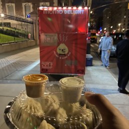a plate of dumplings and dipping sauces