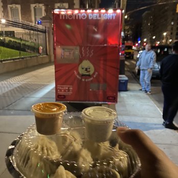 Momo Delight - a plate of dumplings and dipping sauces - Food Trucks Near Me - New York, New York